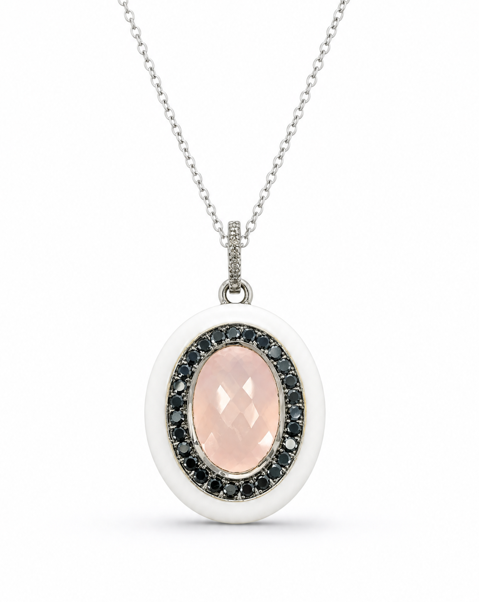 Necklace with a pendant featuring a pink stone and black stones on a white background