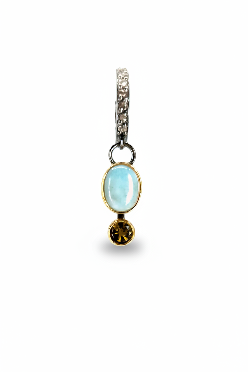 SINGLE DROP EARRING ON A WHITE BACKGROUND