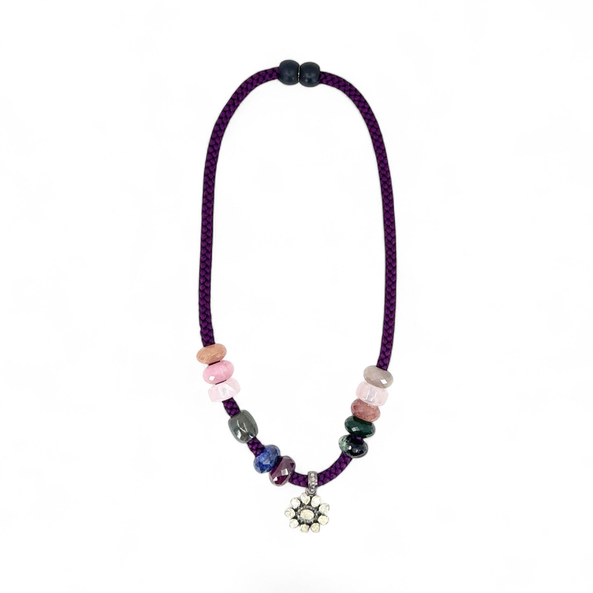 HEILI ROCKS purple braided silk cord necklace with multi-colored gemstone beads and a floral pendant.