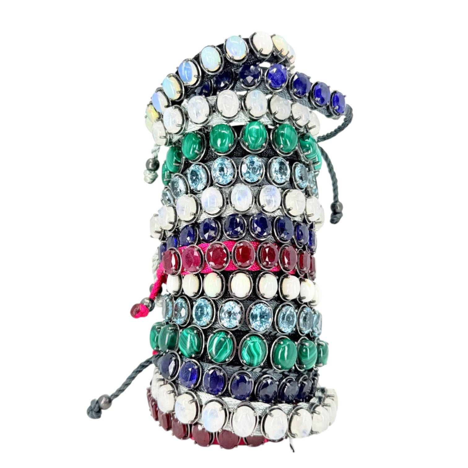 HEILI ROCKS stackable cord bracelets with oval gemstones in blue, green, white, and red, set in sterling silver.