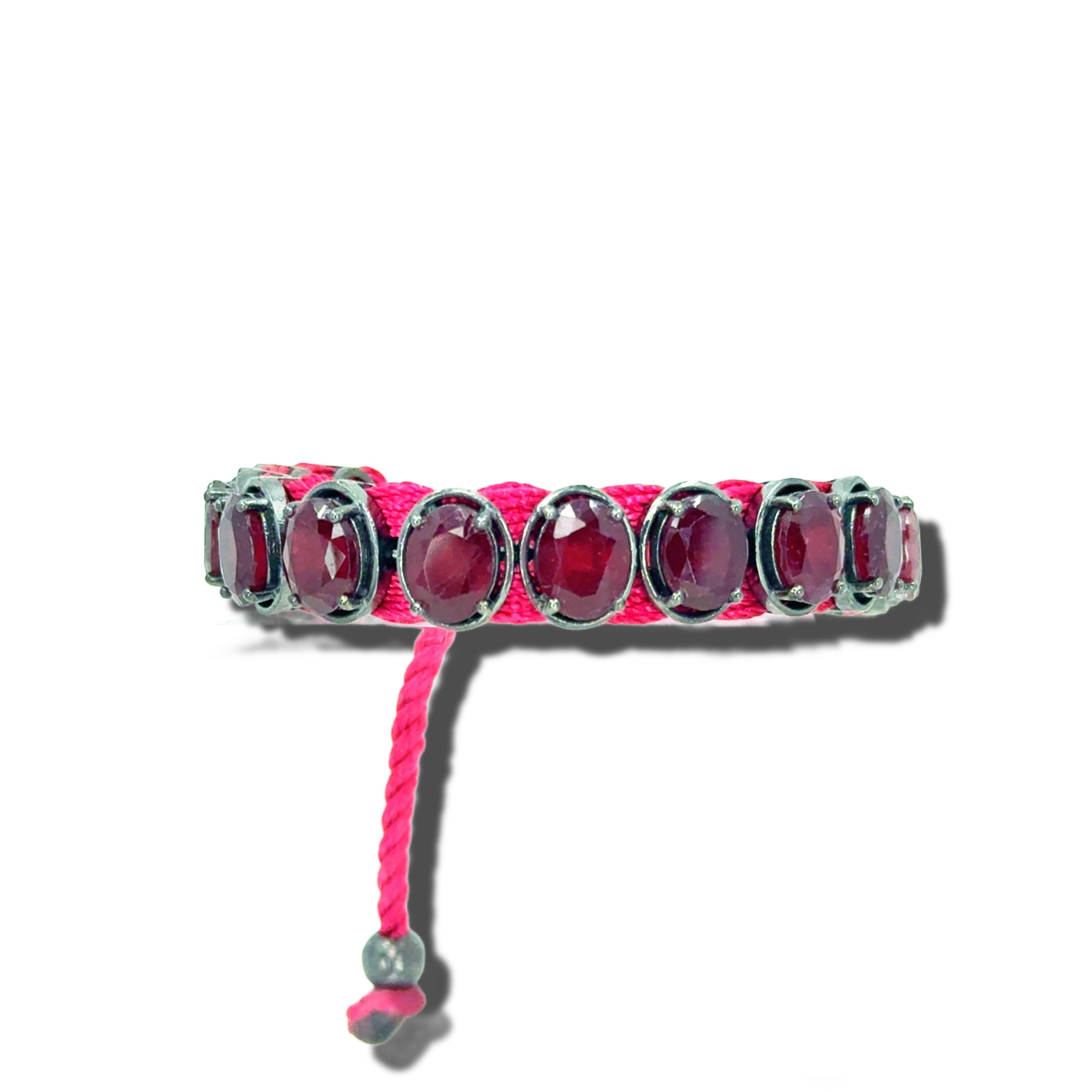 HEILI ROCKS bracelet with oval-cut red gemstones set in sterling silver on a pink cord with adjustable toggle.