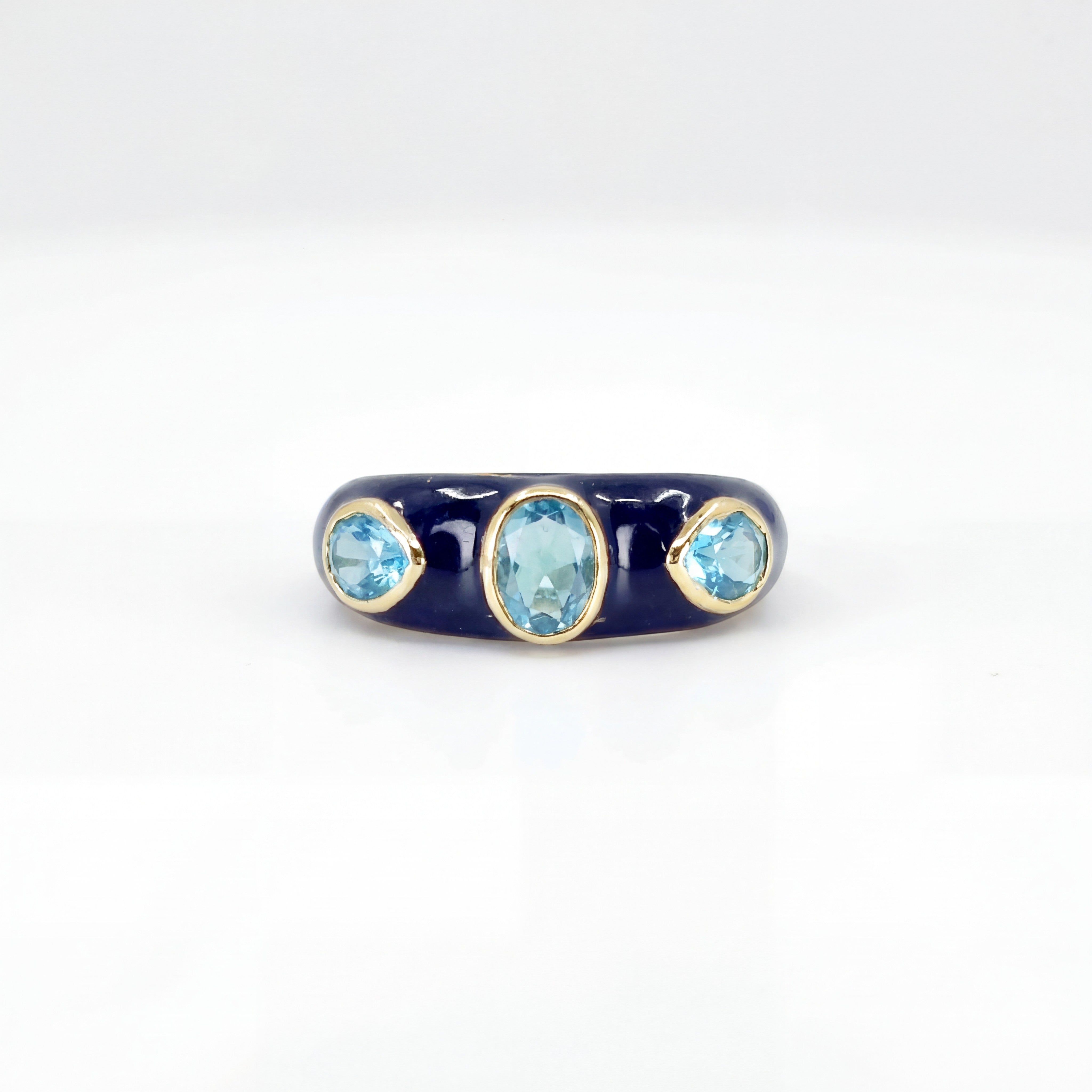HEILI ROCKSH CALLAIS RING: navy enamel band with three oval blue topaz gemstones, sterling silver setting.